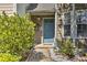 Close up of a blue front door framed by lush landscaping and a brick walkway at 3285 Long Iron Pl, Lawrenceville, GA 30044