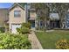 Charming townhome featuring a manicured lawn, blue door, and an attached one car garage at 3285 Long Iron Pl, Lawrenceville, GA 30044