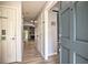 Inviting home hallway showcasing wood floors leading to a living area with a stone fireplace at 3285 Long Iron Pl, Lawrenceville, GA 30044