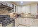 Charming kitchen boasting granite countertops, a tiled backsplash, and black appliances at 3285 Long Iron Pl, Lawrenceville, GA 30044