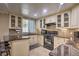 Well-lit kitchen features granite countertops, a tiled backsplash, and ample cabinet storage at 3285 Long Iron Pl, Lawrenceville, GA 30044