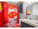 Quirky bathroom with a vibrant shower curtain, single sink vanity, and playful decor at 101 Olympic Ct, Fayetteville, GA 30214