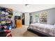 Bright bedroom featuring ample natural light, carpeted floors, and a cozy bed with a patterned comforter at 101 Olympic Ct, Fayetteville, GA 30214