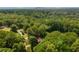 Aerial view of a home nestled among lush trees, offering privacy and a scenic environment at 287 West Wind Dr, Lilburn, GA 30047