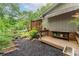 Charming backyard area with a wooden deck, privacy fence, and vibrant, mature landscaping at 287 West Wind Dr, Lilburn, GA 30047
