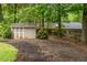 Spacious backyard featuring a storage shed, hammock, and lush landscaping at 287 West Wind Dr, Lilburn, GA 30047