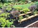 Tranquil backyard patio featuring meticulously arranged bonsai trees and lush landscaping on black mulch at 287 West Wind Dr, Lilburn, GA 30047