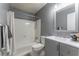 Gray bathroom with a shower-tub combo and a large mirror at 287 West Wind Dr, Lilburn, GA 30047