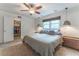 Bedroom featuring a large window, ceiling fan, carpet, and a closet at 287 West Wind Dr, Lilburn, GA 30047