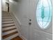 Bright entryway featuring a decorative glass door and wood staircase at 287 West Wind Dr, Lilburn, GA 30047