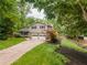 Charming two-story home featuring a well-manicured lawn, attached two-car garage, and lush, mature landscaping at 287 West Wind Dr, Lilburn, GA 30047