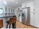 Kitchen featuring stainless steel refrigerator, modern cabinets, and a breakfast bar overlooking the living space at 287 West Wind Dr, Lilburn, GA 30047