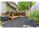 Private outdoor space featuring a wooden deck, built-in shelving, and lush green landscaping at 287 West Wind Dr, Lilburn, GA 30047