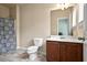 Cozy bathroom featuring a toilet, vanity, and shower with a patterned curtain at 4181 Integrity Way, Powder Springs, GA 30127
