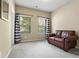 Neutral bedroom showcasing a brown leather love seat, neutral carpet and matching curtains at 4181 Integrity Way, Powder Springs, GA 30127