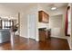 Bright kitchen featuring a built-in desk, stainless appliances, and hardwood floors flowing into the living area at 4181 Integrity Way, Powder Springs, GA 30127