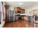 Modern kitchen with stainless steel appliances, dark wood cabinets, and an open layout at 4181 Integrity Way, Powder Springs, GA 30127