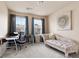 Comfortable home office with a desk, chair, and elegant chaise lounge near windows with blue curtains at 4181 Integrity Way, Powder Springs, GA 30127