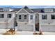 A modern townhome with a brick facade, a one car garage, and complimentary painted shutters at 1287 Fern Ridge Ct # 23, Norcross, GA 30093