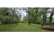 Large backyard space with a wooden deck, bordered by trees and greenery at 1516 Carter Rd, Decatur, GA 30032