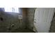 Unfinished basement with concrete walls, a utility sink, and a door, offering potential for customization at 1516 Carter Rd, Decatur, GA 30032