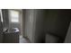 Compact bathroom with a sink, toilet, and enclosed shower featuring a white color scheme at 1516 Carter Rd, Decatur, GA 30032