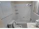 Bathroom featuring a tub/shower combo, standard fixtures, and a large window providing natural light at 1516 Carter Rd, Decatur, GA 30032
