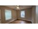 Bedroom features hardwood floors and natural light from windows, enhancing its cozy ambiance at 1516 Carter Rd, Decatur, GA 30032