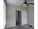 Simple bedroom with neutral walls, a ceiling fan, and a view into a hallway at 1516 Carter Rd, Decatur, GA 30032