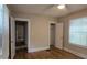 This bedroom features classic hardwood floors, a ceiling fan, and natural light from the windows at 1516 Carter Rd, Decatur, GA 30032