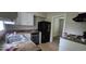 Functional kitchen equipped with standard appliances and ample cabinet space, adjacent to another room at 1516 Carter Rd, Decatur, GA 30032