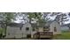 The rear of the home features a small wooden deck and a partially boarded-up back side at 1516 Carter Rd, Decatur, GA 30032