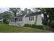 A quaint home features a neatly trimmed yard, classic shuttered windows, and a welcoming front at 1516 Carter Rd, Decatur, GA 30032