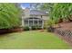A vast backyard view displaying a fenced perimeter, patio area and the home's rear elevation at 1582 E Bank Dr, Marietta, GA 30068