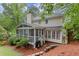 A backyard view showcases the house with a screened-in porch and a built in grilling area at 1582 E Bank Dr, Marietta, GA 30068