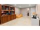 Finished basement area with tile flooring, built-in shelving, and adjacent bathroom at 1582 E Bank Dr, Marietta, GA 30068