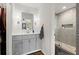 Bathroom with gray vanity, stylish lighting, and a glass-enclosed shower featuring modern tile work at 1582 E Bank Dr, Marietta, GA 30068