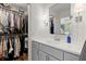 Bathroom with gray vanity, sleek lighting, a walk-in closet, and contemporary finishes at 1582 E Bank Dr, Marietta, GA 30068