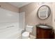 Cozy bathroom featuring tiled floors, an ornate vanity, and a shower-tub combination at 1582 E Bank Dr, Marietta, GA 30068