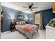 Bedroom featuring a plaid bedspread, blue walls, and bright natural light from the windows at 1582 E Bank Dr, Marietta, GA 30068