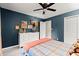 Bedroom featuring a plaid bedspread, blue walls, and bright natural light from the windows at 1582 E Bank Dr, Marietta, GA 30068