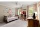 Cozy bedroom featuring a twin bed, a dollhouse, and soft natural lighting at 1582 E Bank Dr, Marietta, GA 30068