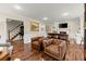 Cozy living room with hardwood floors, a fireplace, and tufted leather chairs at 1582 E Bank Dr, Marietta, GA 30068