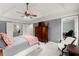 The primary bedroom features a tray ceiling, fan, sitting area and an ensuite bathroom at 1582 E Bank Dr, Marietta, GA 30068