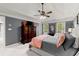 The primary bedroom features a tray ceiling, fan, sitting area and a dresser with a TV at 1582 E Bank Dr, Marietta, GA 30068