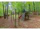 Backyard play area with a wooden playset featuring slides, a climbing wall, and swings at 1582 E Bank Dr, Marietta, GA 30068