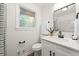 Modern bathroom with a new vanity, decorative mirror, and shower with white marble at 2011 W Starmount Way, Decatur, GA 30032