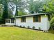 Attractive single-story home featuring white brick, wood shutters, and green front lawn at 2011 W Starmount Way, Decatur, GA 30032