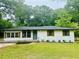 Charming single-story home with a well-manicured front yard, complemented by mature trees at 2011 W Starmount Way, Decatur, GA 30032