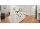 Stylish kitchen showcasing white cabinets, an island with seating, and hardwood floors at 2011 W Starmount Way, Decatur, GA 30032